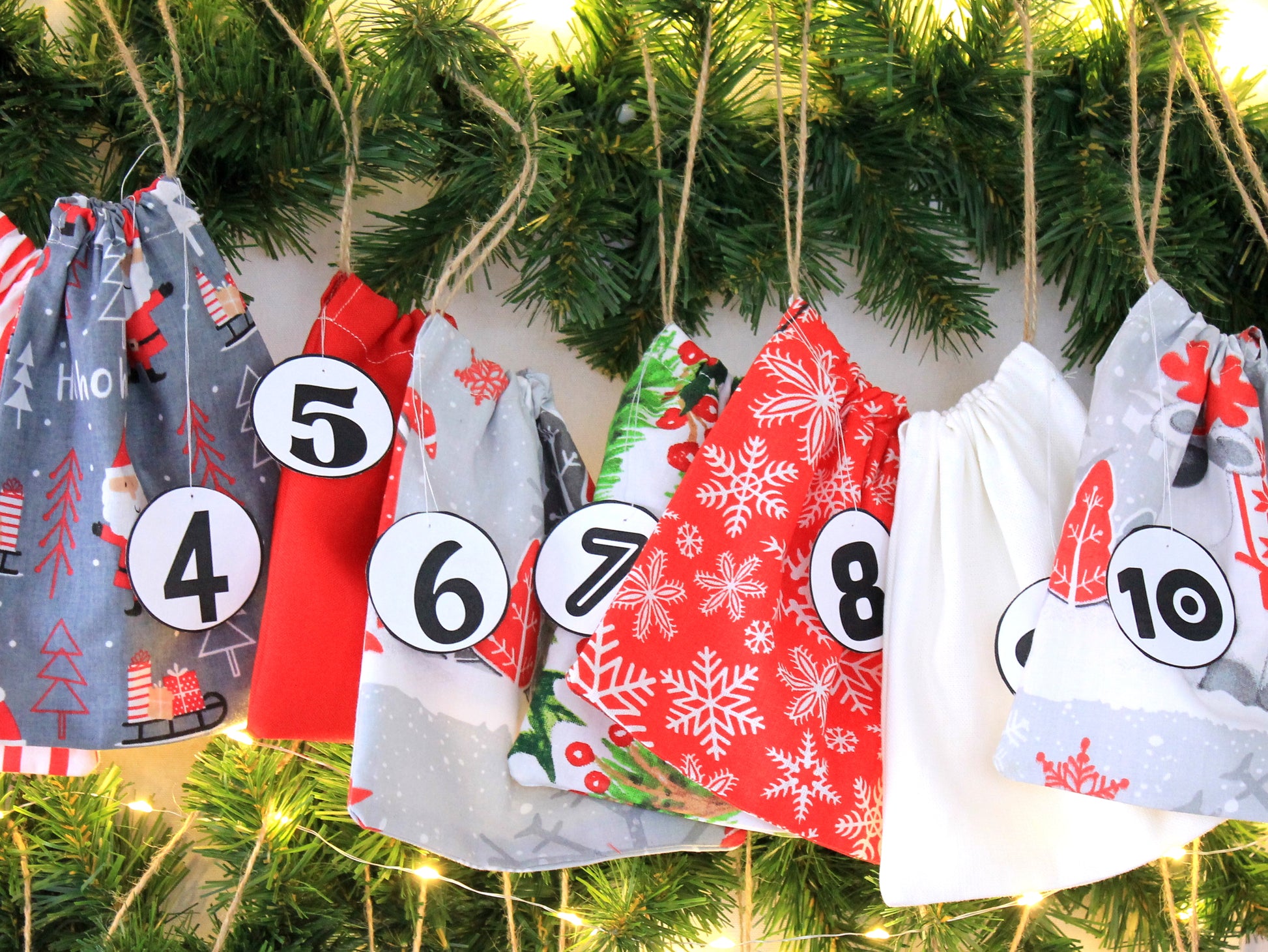 Advent calendar bags hung on wall – ready for holiday countdown - sewing pattern by NatkoPatterns