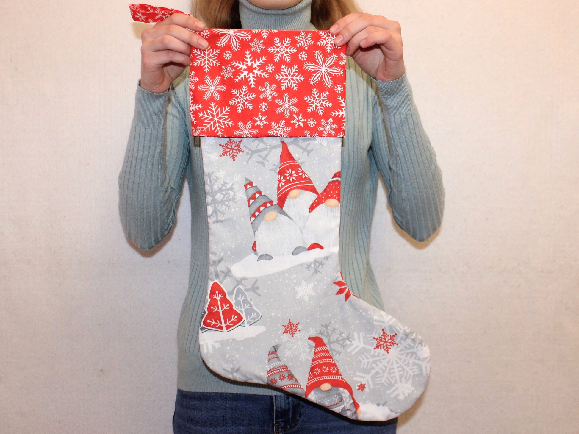 Person holding a Christmas stocking with gnome and snowflake - pattern pdf