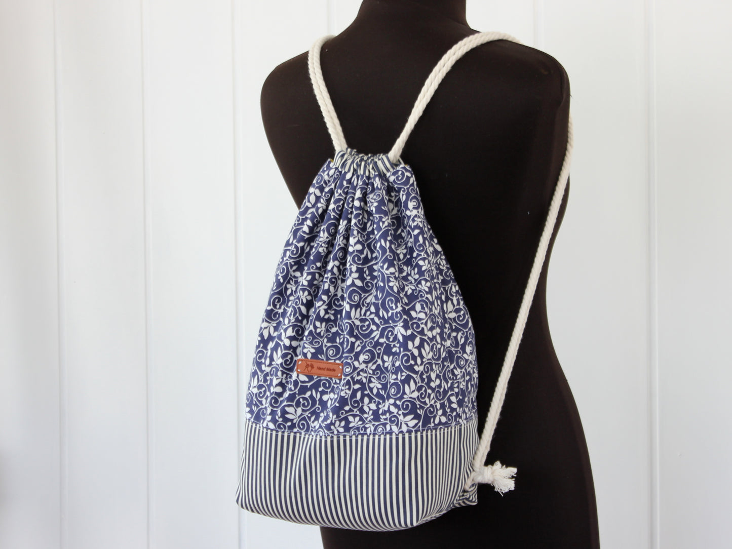 Drawstring backpack on a mannequin, easy sewing pattern PDF with templates