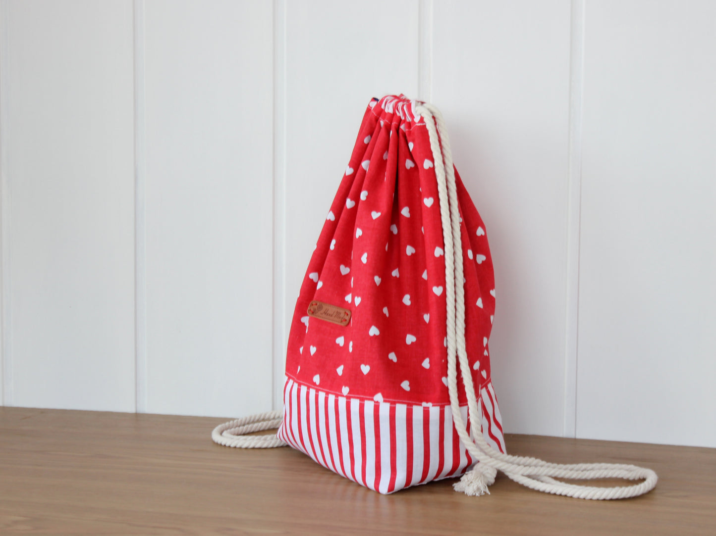 Side view of handmade drawstring backpack – sewing project by NatkoPatterns