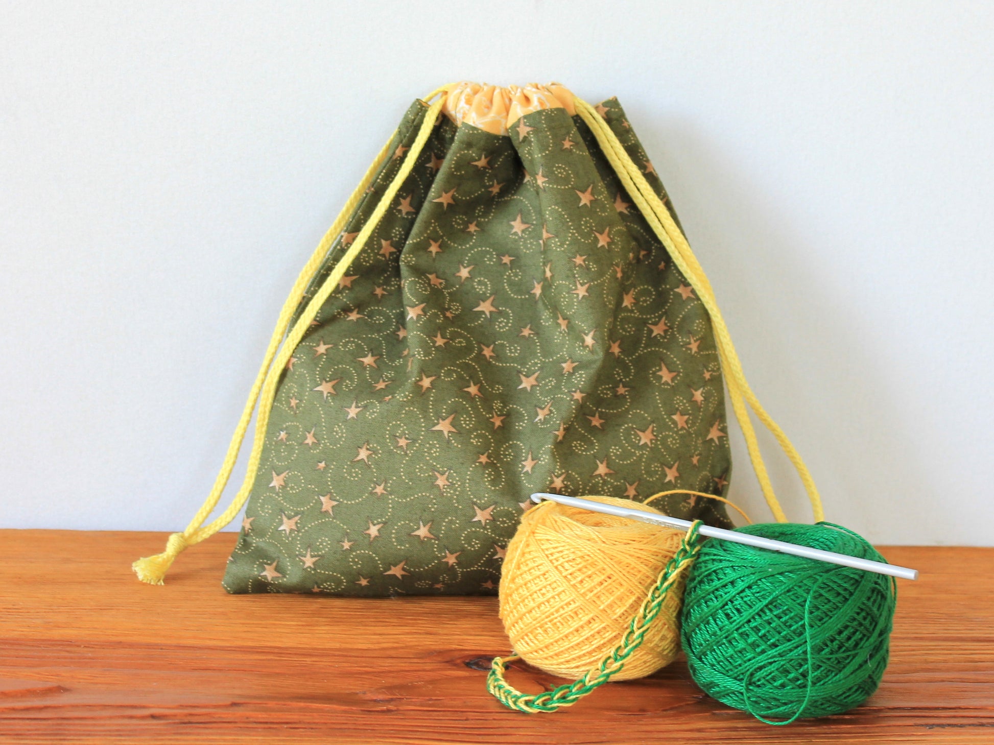 Green drawstring bag with yarn and knitting needles - sewing pattern for beginner
