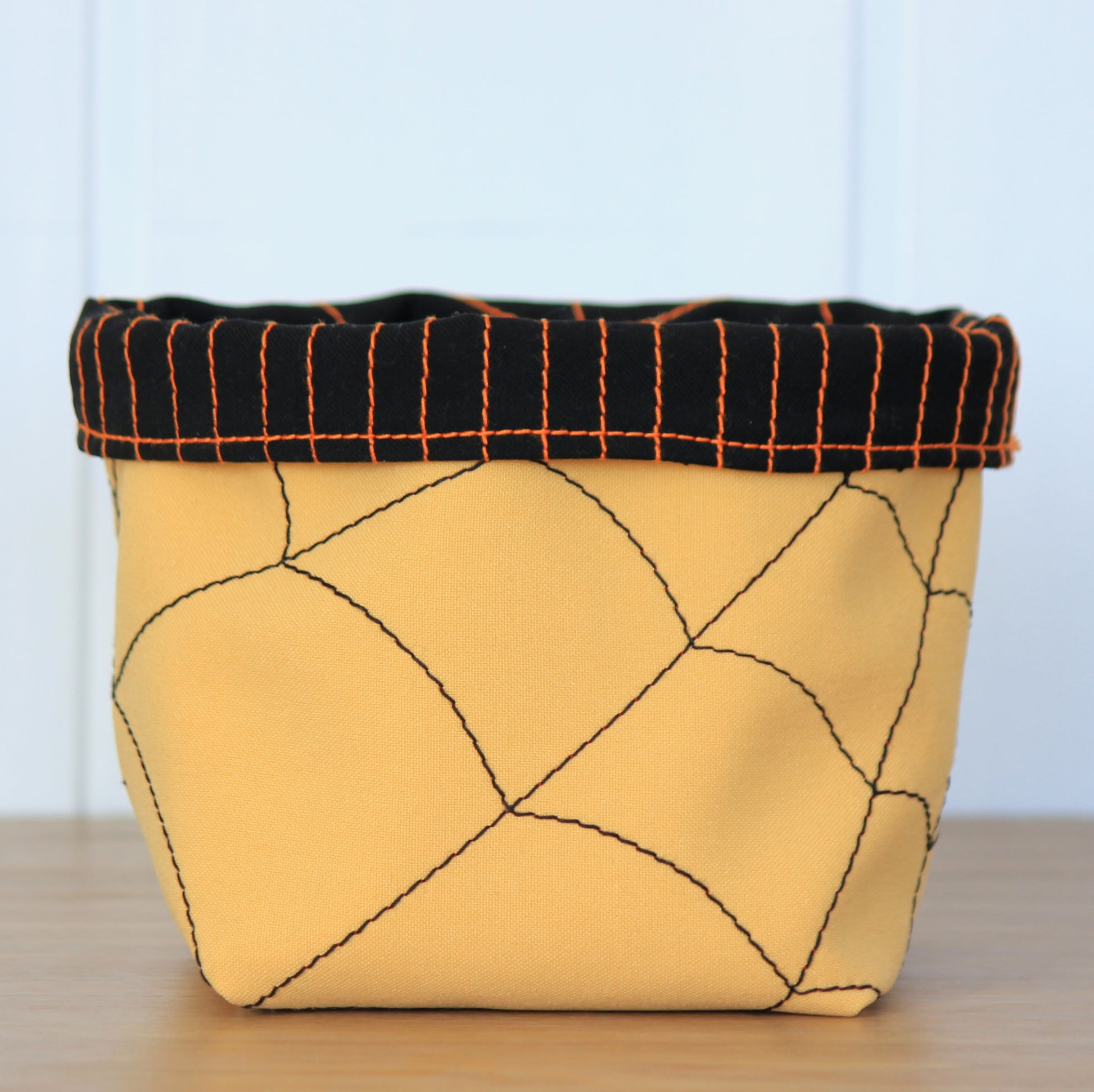 Yellow fabric basket with spyder stitching for Halloween holidays - sewing pattern by NatkoPatterns