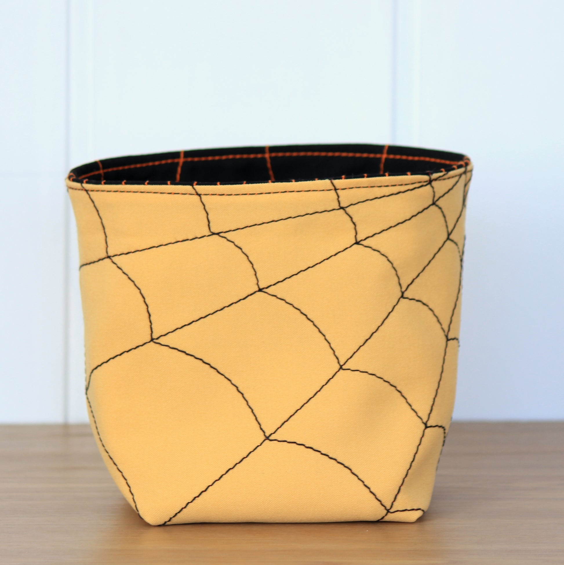 Yellow fabric basket with Halloween design - beginner friendly sewing project by NatkoPatterns