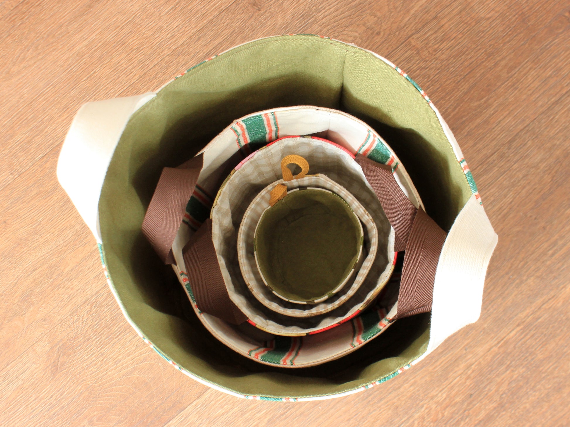 All five round fabric basket sizes nested together to show the finished dimensions of the NatkoPatterns sewing pattern