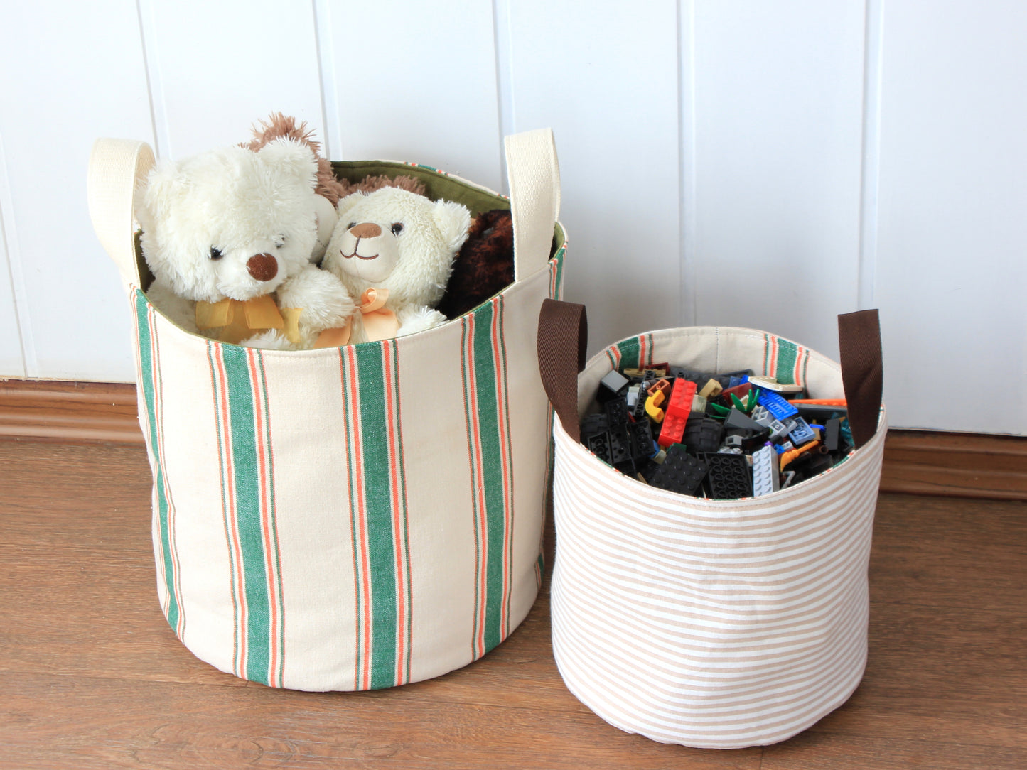 Round fabric basket organizers made with the NatkoPatterns sewing pattern and filled with kids toys