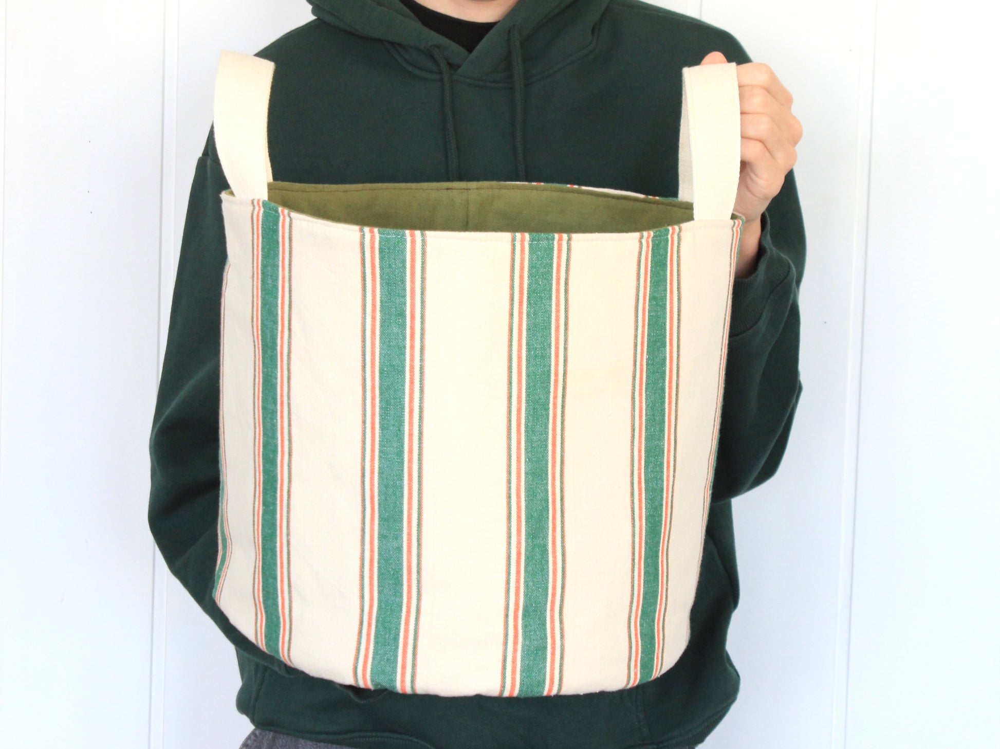 XL round fabric basket made with the NatkoPatterns sewing pattern, shown in hand to display the largest finished size