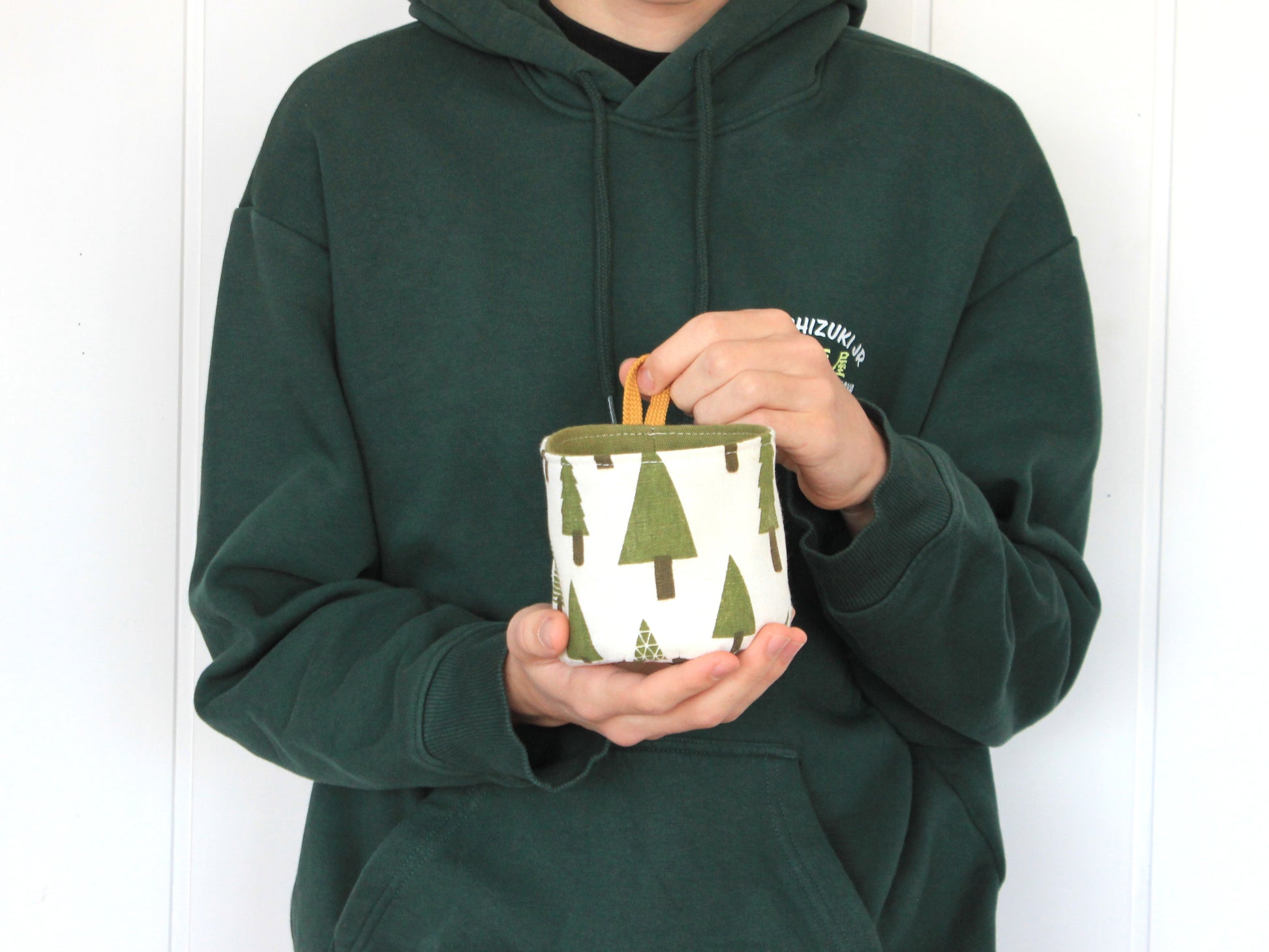 XS round fabric basket made with the NatkoPatterns sewing pattern, shown in hand to demonstrate the finished size