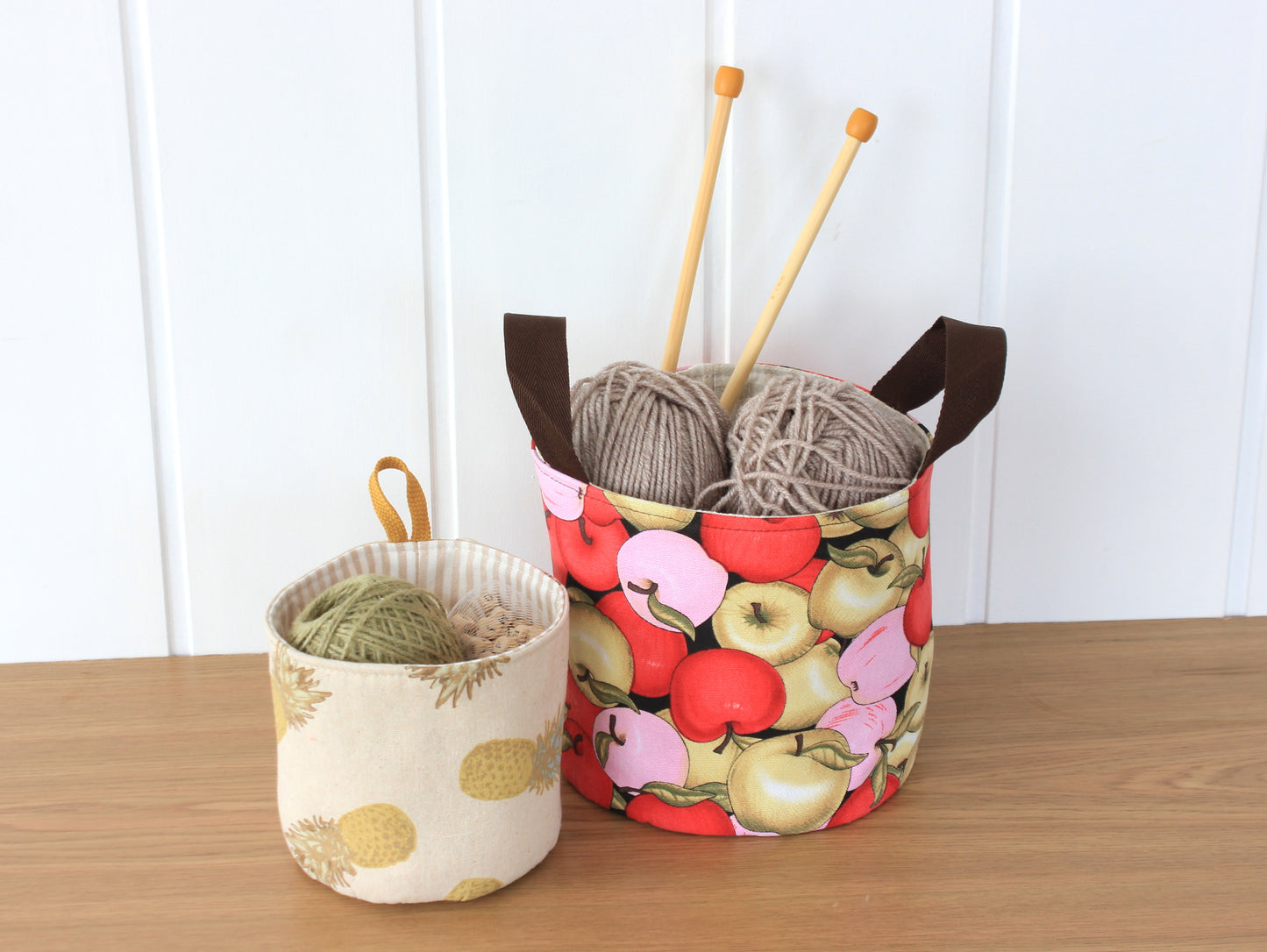 Round fabric basket organizers made with the NatkoPatterns sewing pattern and filled with sewing supplies