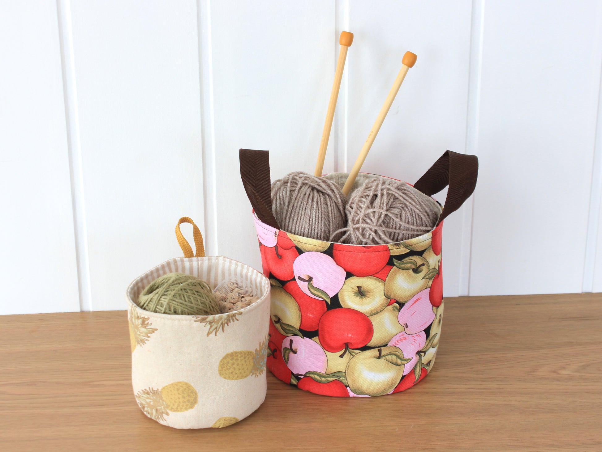 Round fabric basket organizers made with the NatkoPatterns sewing pattern and filled with sewing supplies