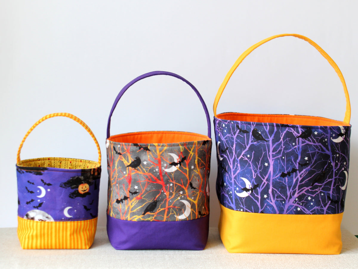 NatkoPatterns handmade Halloween fabric baskets in small, medium and large sizes with colorful prints and contrasting handles.