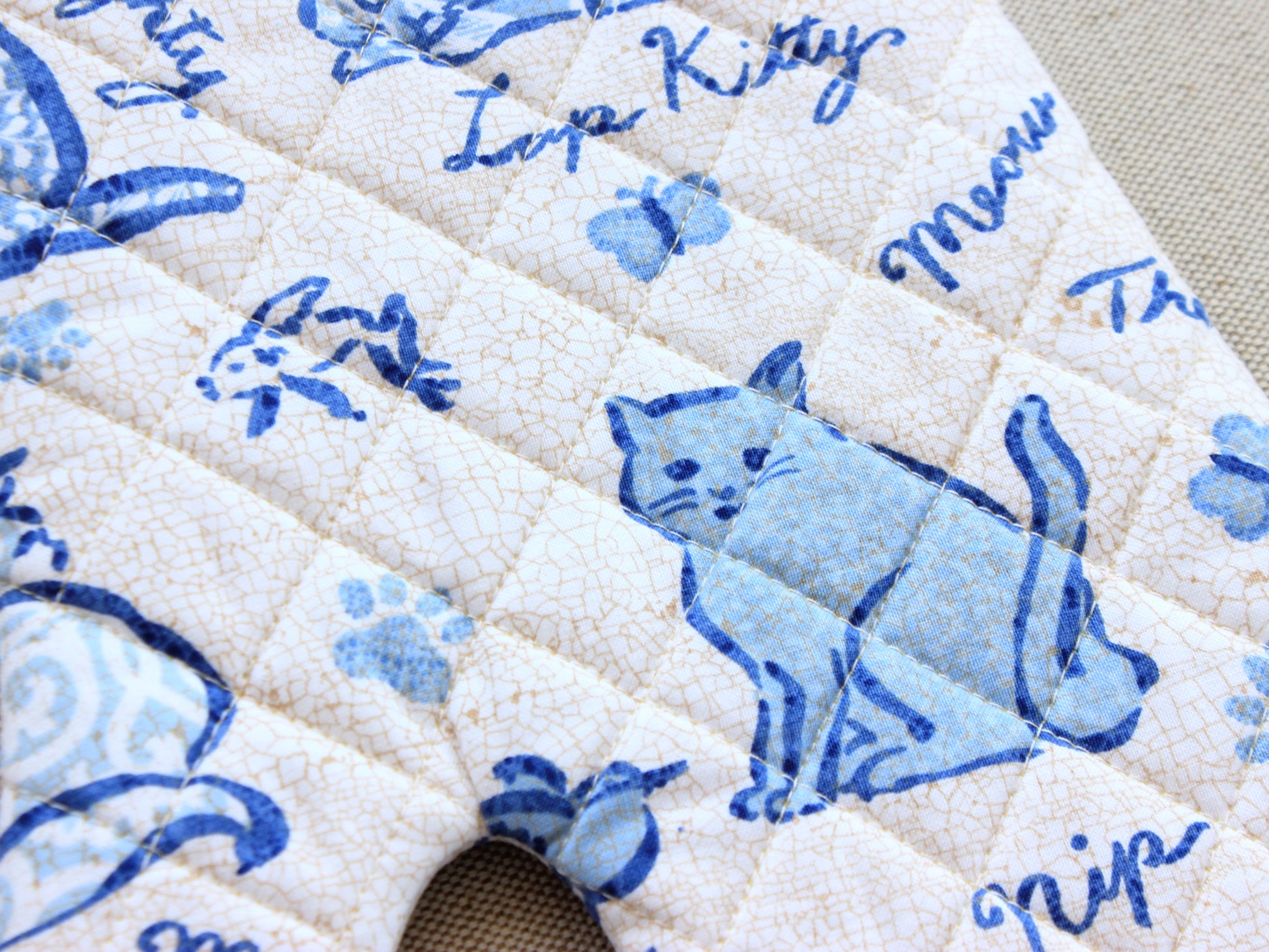 Close-up quilting stitches on handmade oven mitt
