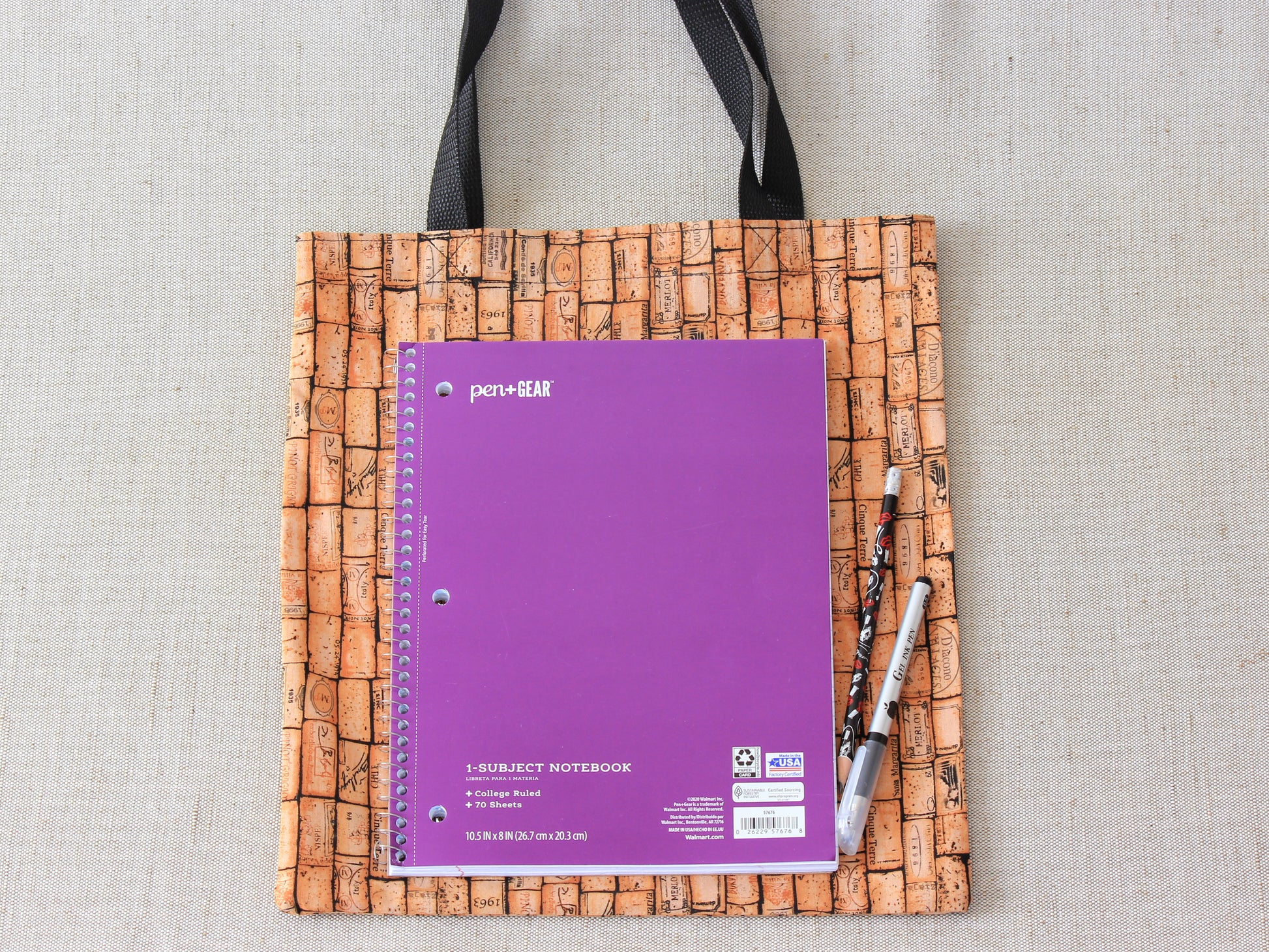 A school magazine is lying on a tote bag.